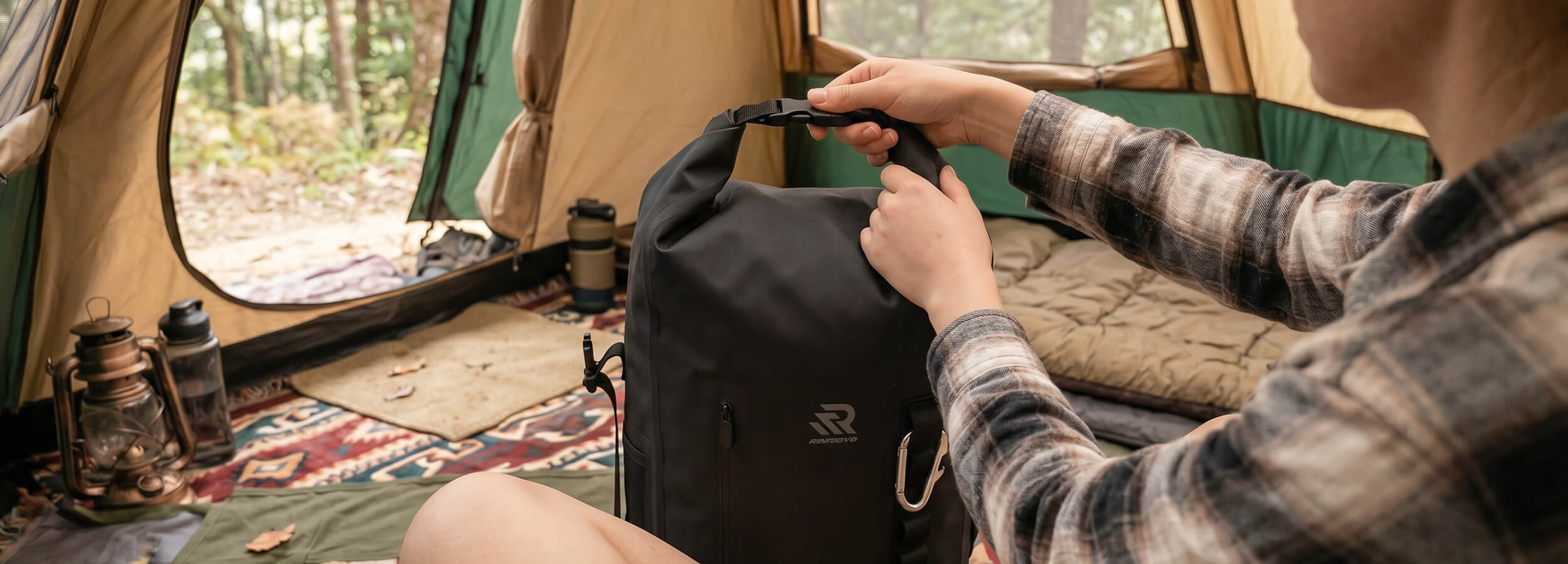 a people is rolling up the rivonova backpack cooler