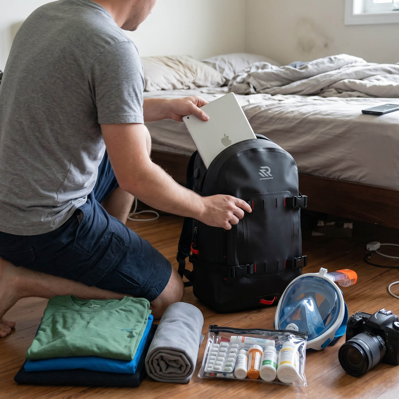 RIVONOVA waterproof backpack with large capacity storing a laptop, clothing, camera, and outdoor essentials.