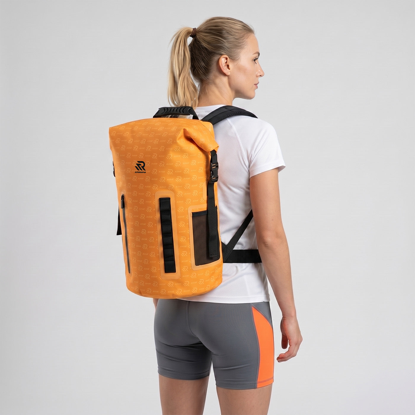 Back view of a man wearing a Rivonova roll-top backpack cooler black