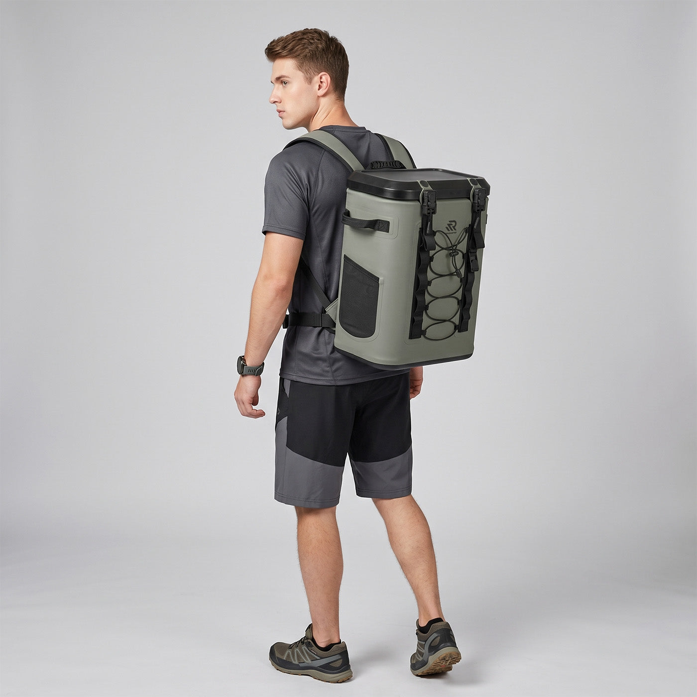 Back view of a man wearing a Rivonova waterproof soft cooler green
