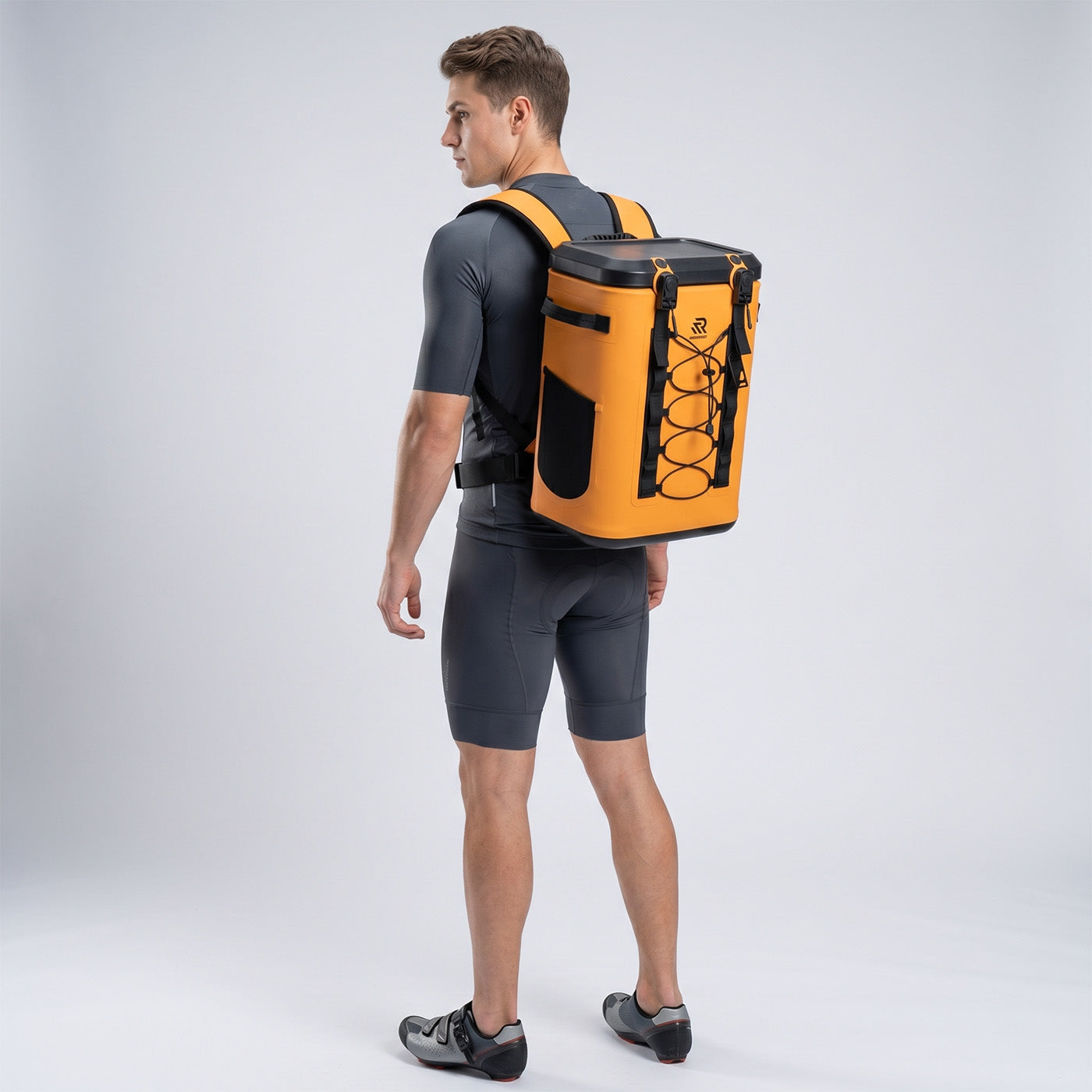 Back view of a man wearing a Rivonova waterproof soft cooler orange