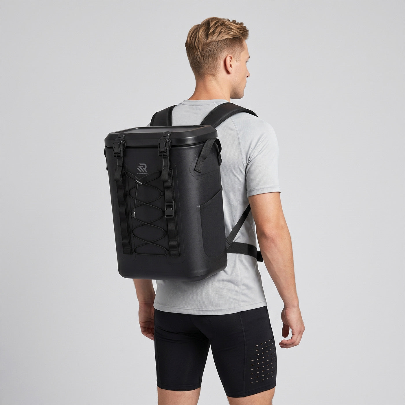 Back view of a man wearing a Rivonova waterproof soft cooler black