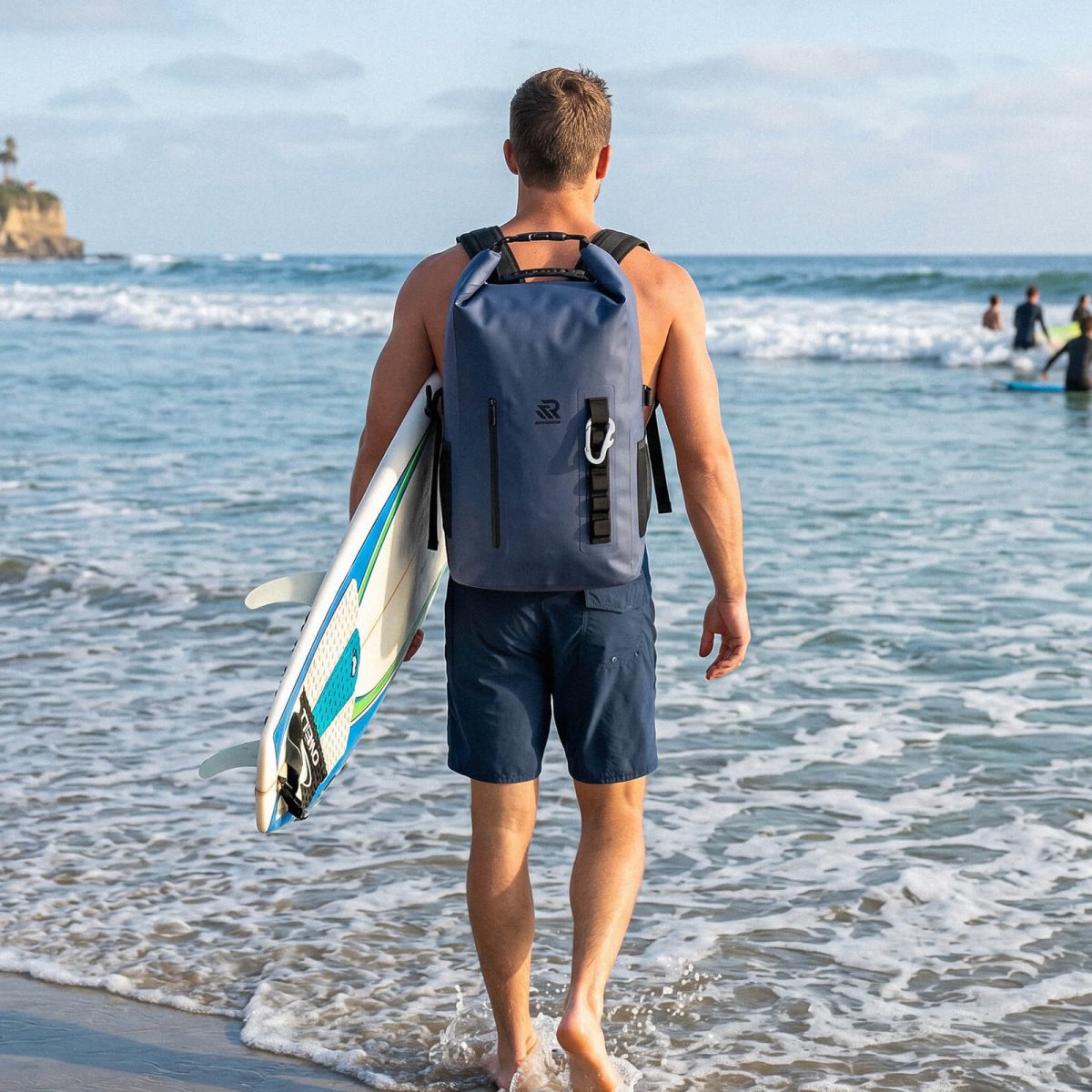 RIVONOVA 20L Roll-Top Backpack Cooler in Navy - lifestyle beach scene#Color_navy
